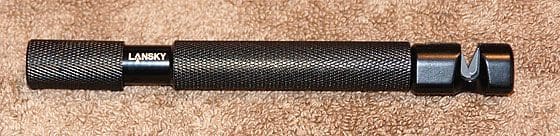 A close up of the end of a black handle.