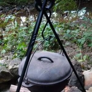 A pot on the ground with a tripod