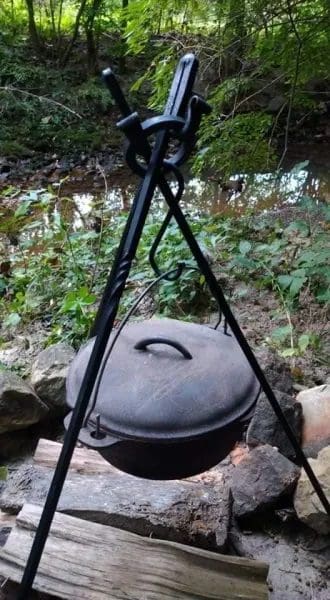 A pot on the ground with a tripod