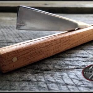 A wooden handle with a metal knife on it.