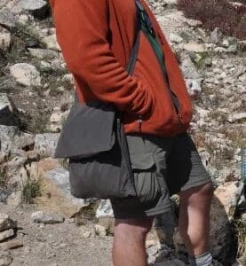 A man with a red shirt and black bag