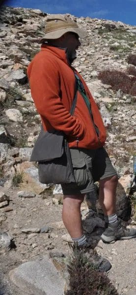 A man with a red shirt and black bag