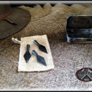 A pair of knives sitting on top of a rug.