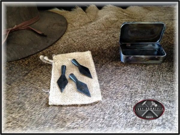 A pair of knives sitting on top of a rug.