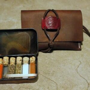 A purse and a case with many bottles of medicine.