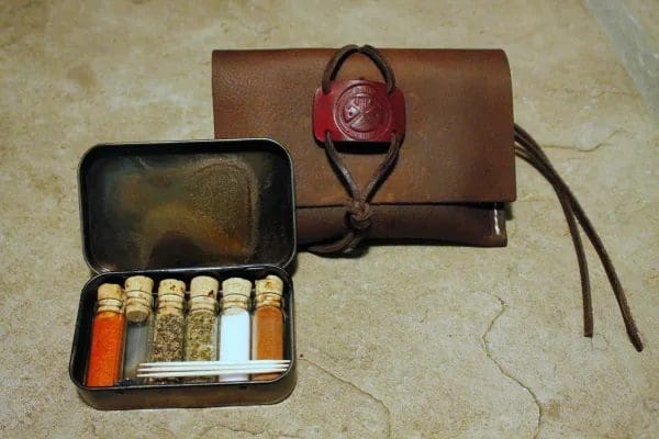 A purse and a case with many bottles of medicine.