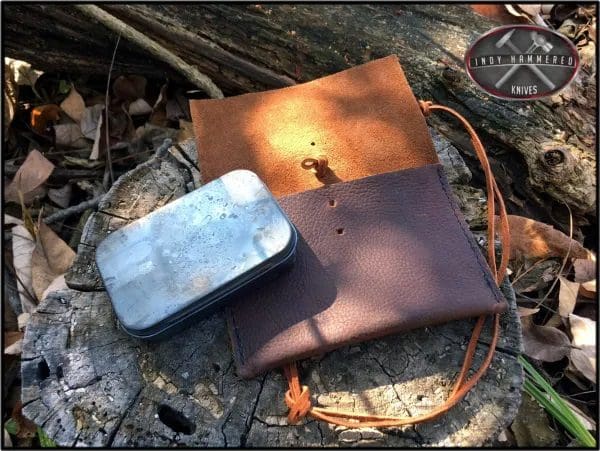 A bag and tin sitting on the ground.