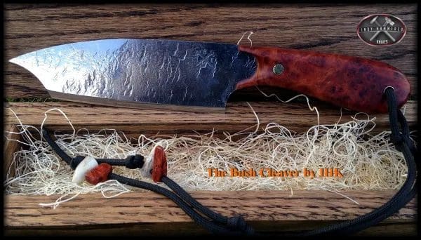 A knife and some tools on top of wood.