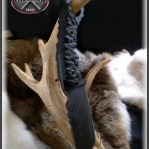 A knife that is on top of some antlers.