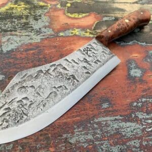 A knife with an engraved design on it.