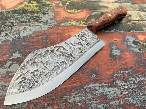 A knife with an engraved design on it.