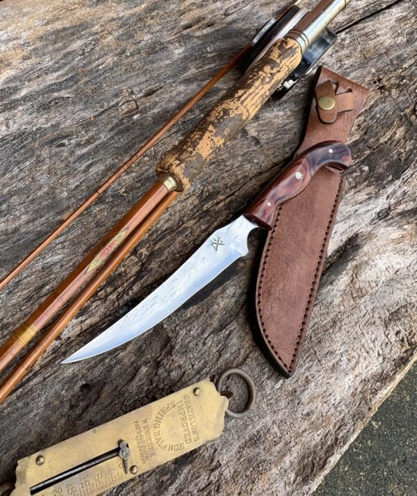 A knife and some wooden sticks on top of a table.