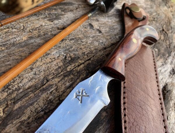 A knife and some leather on the ground