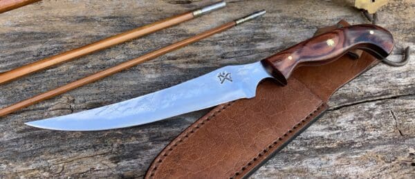 A knife and some chopsticks on top of a table.